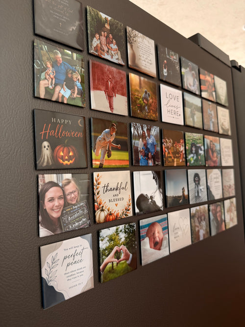A fridge door covered in dozens of 2.5 inch photo magnets — family photographs, pets, and lettered keepsakes.