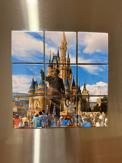 A photograph of a castle split across nine magnets on a stainless fridge door